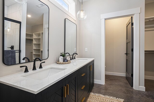 6426 Henry St, Norton Shores, MI 49441 - full bath featuring a spacious closet, baseboards, a sink, and finished concrete flooring