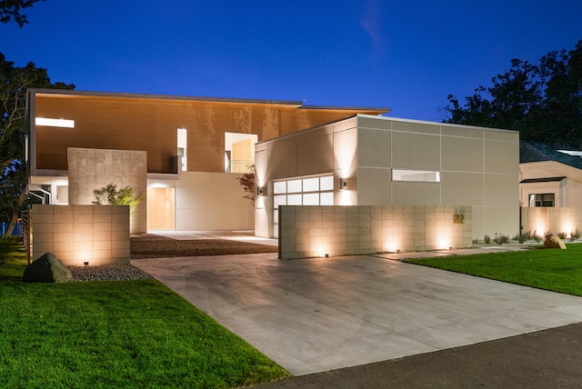 602 Lawn Ave, Holland, MI 49424 - contemporary house with a garage, a lawn, stucco siding, and concrete driveway