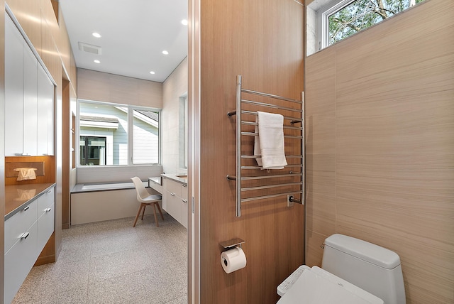 602 Lawn Ave, Holland, MI 49424 - bathroom with recessed lighting, radiator heating unit, visible vents, toilet, and vanity