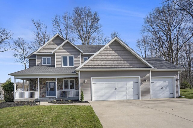8560 Western Woods Dr, Kalamazoo, MI 49009 - view of front of home with concrete driveway, stone siding, an attached garage, a porch, and a front yard
