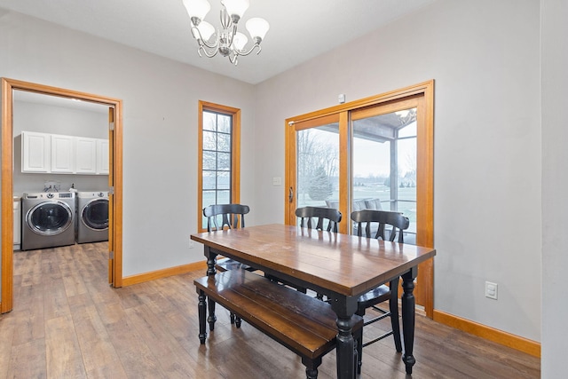 2776 W Hogan Dr, La Porte, IN 46350 - dining room with independent washer and dryer, a chandelier, baseboards, and light wood finished floors
