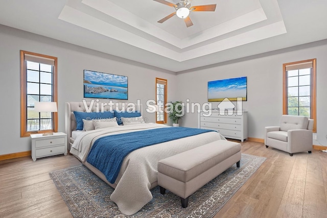 2776 W Hogan Dr, La Porte, IN 46350 - bedroom featuring a raised ceiling, light wood-type flooring, and baseboards