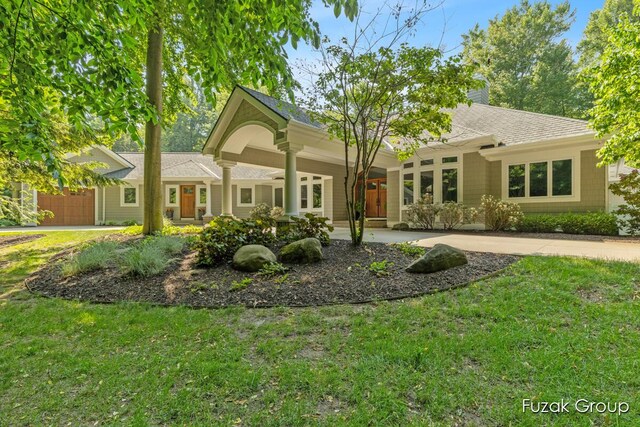 17180 Shore Oaks W Ln, Holland, MI 49424 - view of front of home featuring a front lawn, a shingled roof, and a chimney