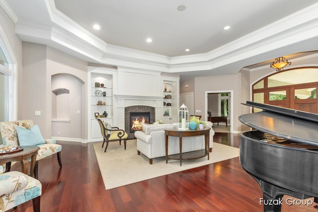 17180 Shore Oaks W Ln, Holland, MI 49424 - living room featuring a tray ceiling, ornamental molding, dark wood finished floors, a high end fireplace, and recessed lighting