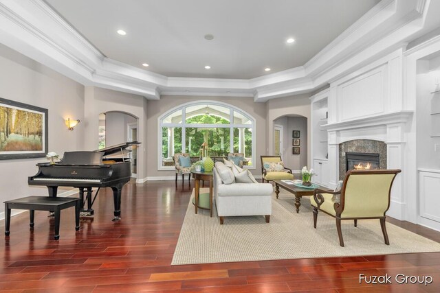 17180 Shore Oaks W Ln, Holland, MI 49424 - living area featuring crown molding, a tray ceiling, a glass covered fireplace, dark wood-style floors, and recessed lighting