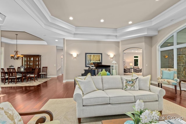 17180 Shore Oaks W Ln, Holland, MI 49424 - living room with wood finished floors, a raised ceiling, crown molding, a chandelier, and recessed lighting