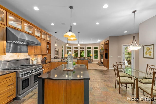 17180 Shore Oaks W Ln, Holland, MI 49424 - kitchen featuring double oven range, under cabinet range hood, a center island, healthy amount of natural light, and recessed lighting