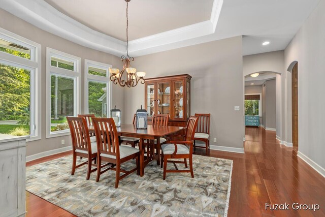17180 Shore Oaks W Ln, Holland, MI 49424 - dining space with arched walkways, wood finished floors, a chandelier, a tray ceiling, and recessed lighting