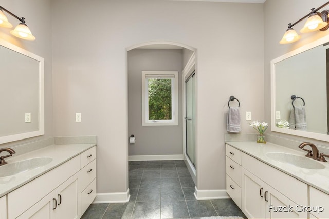 17180 Shore Oaks W Ln, Holland, MI 49424 - full bath with two vanities, tile patterned flooring, and an enclosed shower