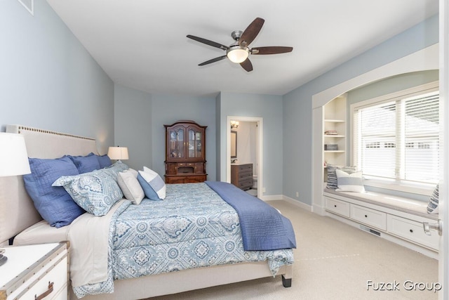 17180 Shore Oaks W Ln, Holland, MI 49424 - bedroom with light colored carpet, connected bathroom, and ceiling fan