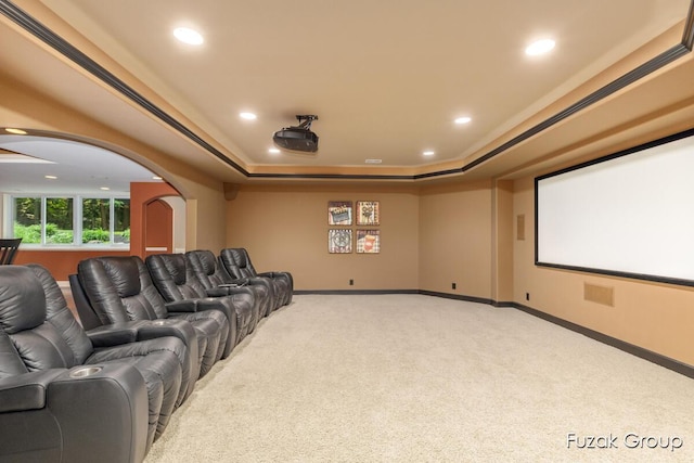 17180 Shore Oaks W Ln, Holland, MI 49424 - carpeted cinema room featuring arched walkways, a raised ceiling, and recessed lighting