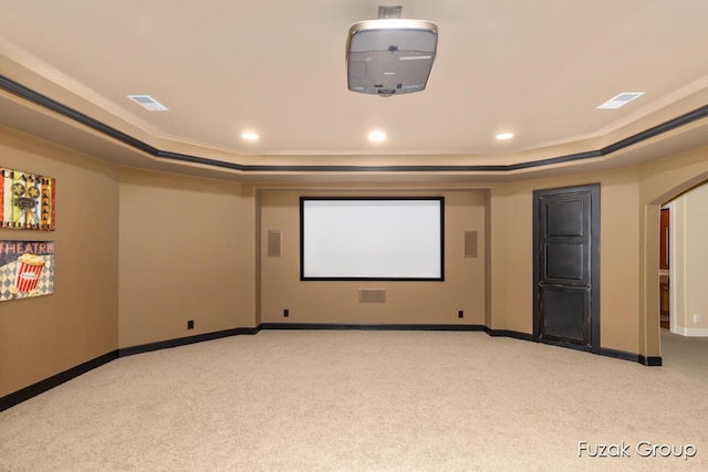 17180 Shore Oaks W Ln, Holland, MI 49424 - cinema with light carpet, a raised ceiling, arched walkways, and recessed lighting