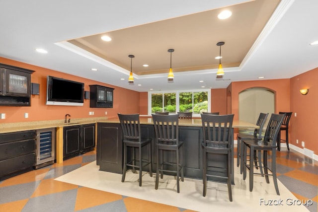 17180 Shore Oaks W Ln, Holland, MI 49424 - indoor wet bar with beverage cooler, a tray ceiling, recessed lighting, and pendant lighting