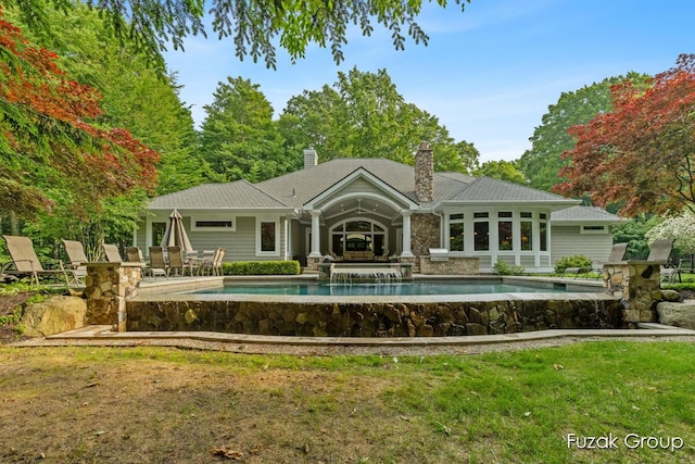 17180 Shore Oaks W Ln, Holland, MI 49424 - rear view of property featuring an outdoor pool, a chimney, and a lawn