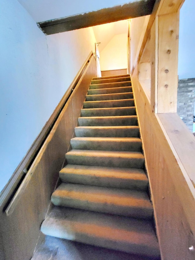 stairway featuring vaulted ceiling