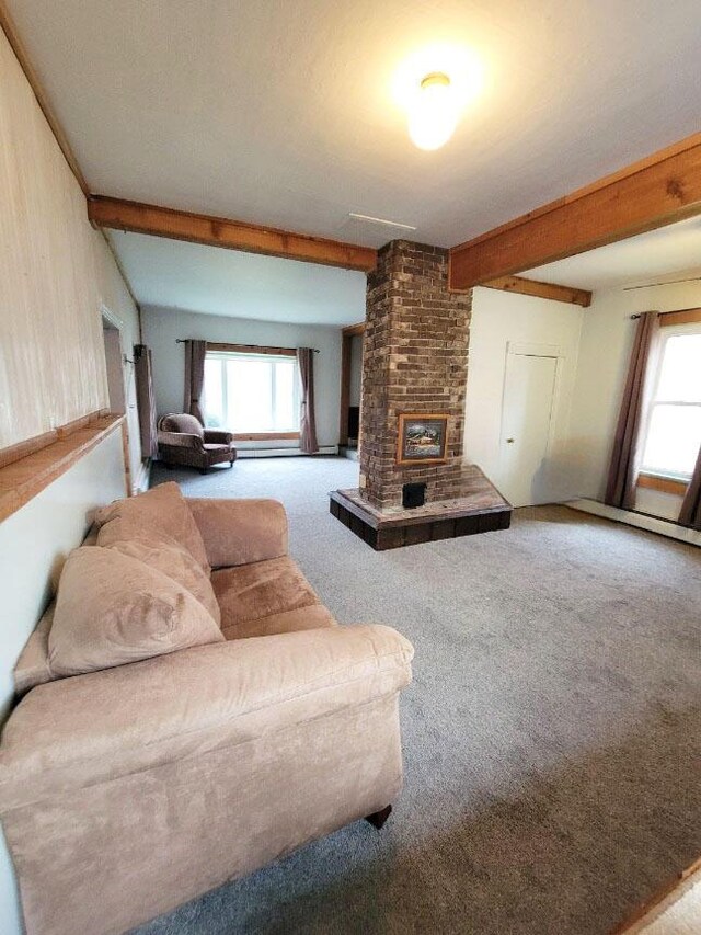 living room featuring carpet, plenty of natural light, and beamed ceiling