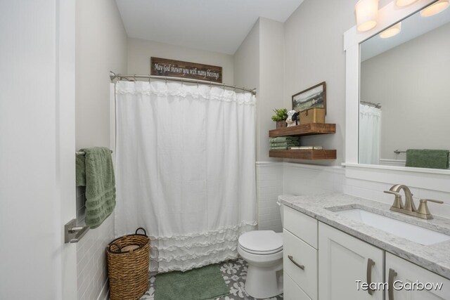 8393 Woodhaven Dr SW Unit 01, Byron Center, MI 49315 - bathroom with vanity, tile walls, toilet, tile patterned flooring, and a shower with shower curtain