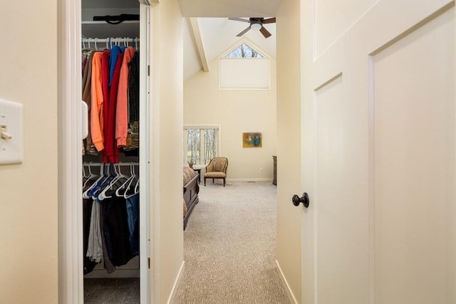 interior space featuring high vaulted ceiling, ceiling fan, beamed ceiling, and carpet