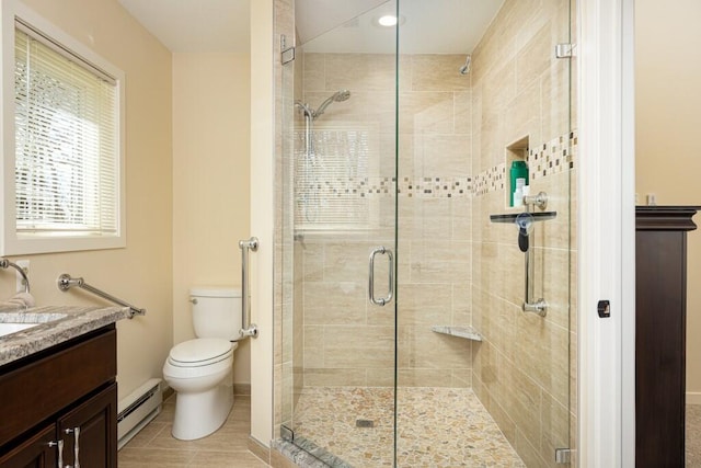 full bathroom featuring baseboard heating, baseboards, vanity, and a stall shower