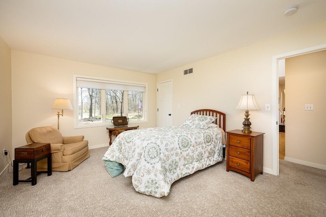 carpeted bedroom with baseboards and visible vents