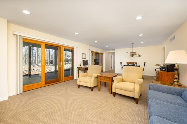 living room featuring recessed lighting and light colored carpet