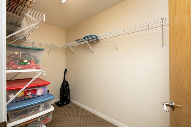 walk in closet with carpet