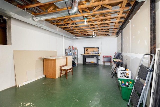 unfinished basement featuring a workshop area