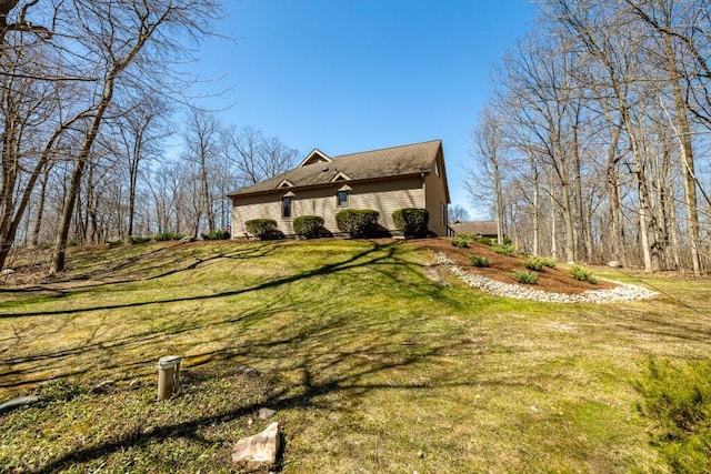 view of side of property with a lawn
