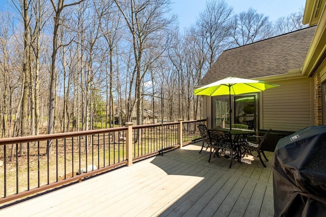 deck with grilling area and outdoor dining area