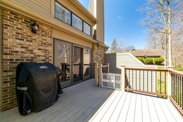 wooden terrace featuring grilling area