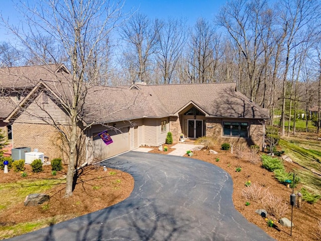 ranch-style home featuring brick siding, driveway, and a garage