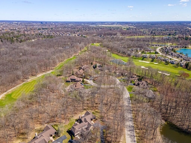drone / aerial view with view of golf course, a water view, and a residential view