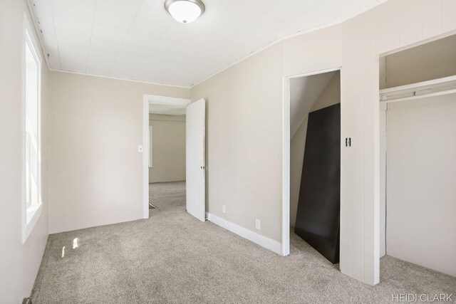 3552 47th St, Hamilton, MI 49419 - unfurnished bedroom featuring a closet, multiple windows, and carpet
