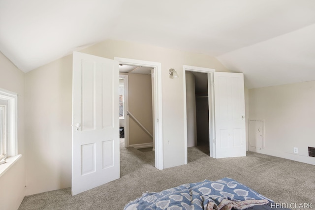3552 47th St, Hamilton, MI 49419 - unfurnished bedroom featuring lofted ceiling, visible vents, and carpet