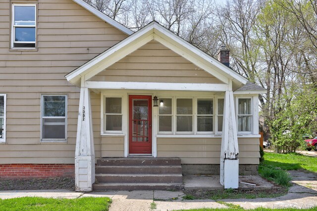 3552 47th St, Hamilton, MI 49419 - view of front of home with a shingled roof, entry steps, and a chimney