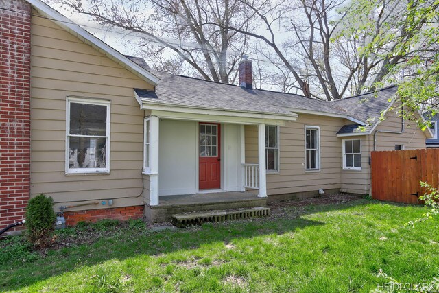 3552 47th St, Hamilton, MI 49419 - view of front of home featuring fence, roof with shingles, a chimney, and a front yard