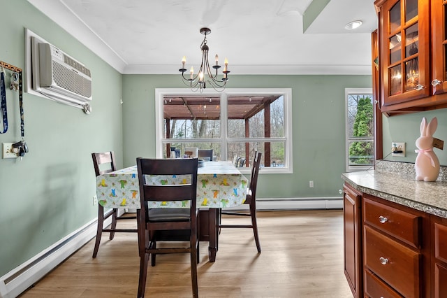 419 Larkspur Ave, Portage, MI 49002 - dining space with a wall mounted air conditioner, light wood finished floors, baseboard heating, and an inviting chandelier