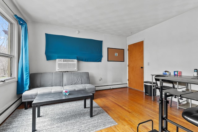 419 Larkspur Ave, Portage, MI 49002 - living area with a baseboard heating unit, a wall mounted AC, and wood finished floors