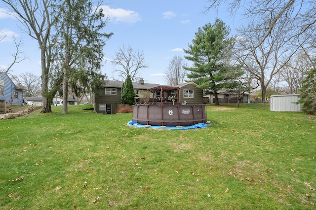 419 Larkspur Ave, Portage, MI 49002 - view of yard featuring an outdoor structure, fence, and an outdoor pool