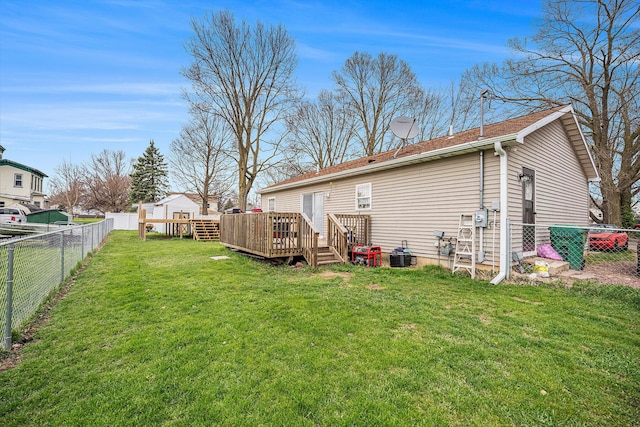103 S Leeth St, White Pigeon, MI 49099 - back of house featuring a wooden deck, a lawn, a fenced backyard, and central AC unit