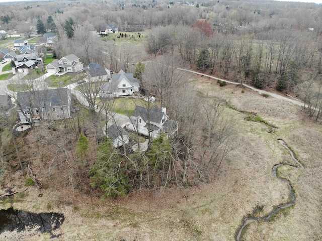 birds eye view of property featuring a residential view and a wooded view