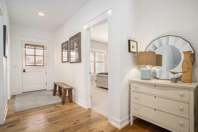 doorway with recessed lighting, light wood-style floors, plenty of natural light, and baseboards