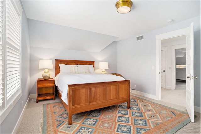 bedroom featuring light carpet, visible vents, and baseboards