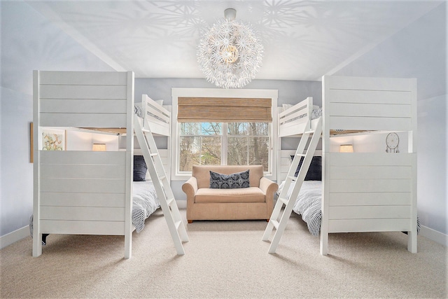 carpeted bedroom with baseboards and a chandelier