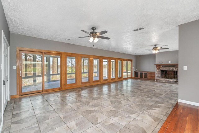 11886 Riverside Dr, White Pigeon, MI 49099 - unfurnished living room with baseboards, a ceiling fan, a textured ceiling, and visible vents