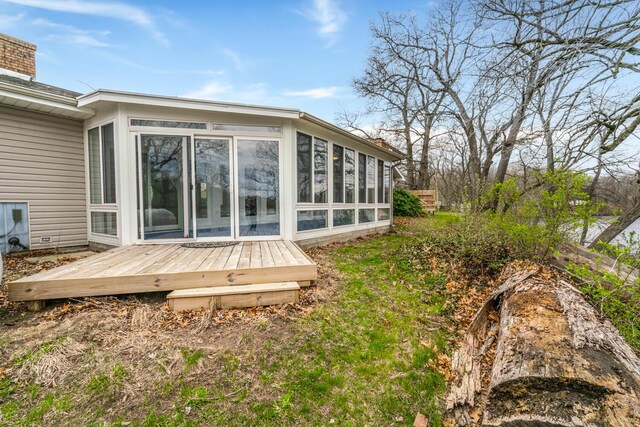 11886 Riverside Dr, White Pigeon, MI 49099 - rear view of property featuring a wooden deck, a sunroom, and a chimney