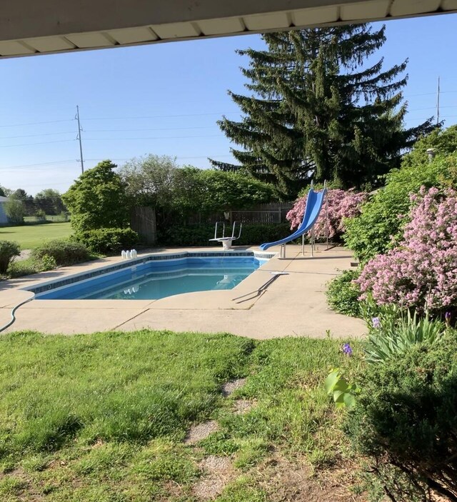 11886 Riverside Dr, White Pigeon, MI 49099 - pool featuring a water slide, fence, a patio, and a lawn