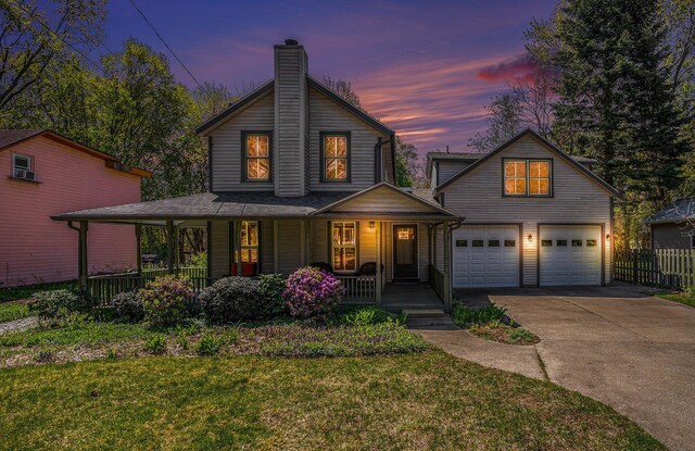 251 N St, Saugatuck, MI 49453 - view of front of house with a porch, a garage, a chimney, and concrete driveway