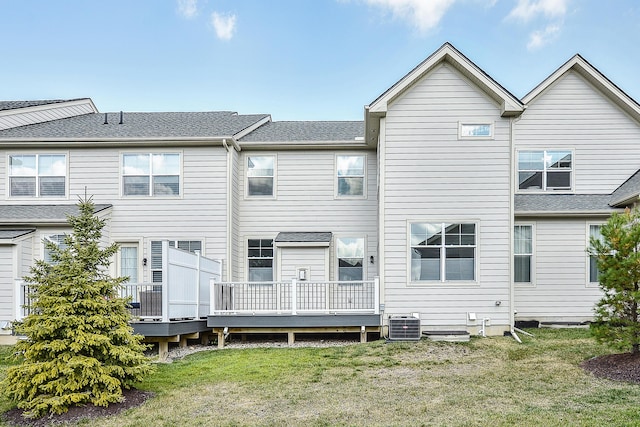 rear view of property with a lawn and a deck