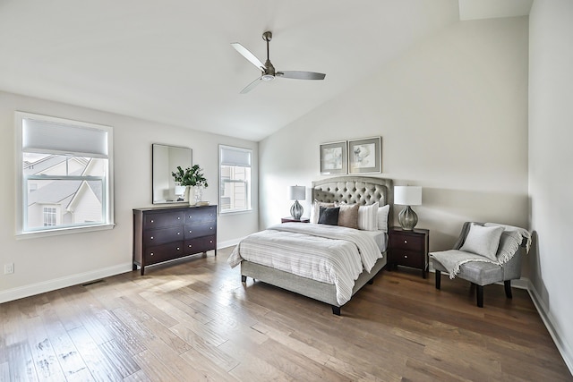 bedroom featuring high vaulted ceiling, a ceiling fan, wood finished floors, baseboards, and visible vents